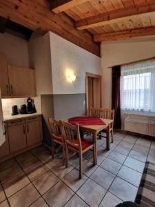 a kitchen with a table and chairs in a room at Landhaus Nageler in Westendorf