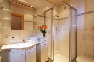 a bathroom with a shower and a sink and a toilet at Landhaus Nageler in Westendorf +93 photos