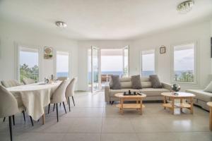 a living room with a table and a couch and chairs at Perseus in Cape Sarakiniko in Argostoli