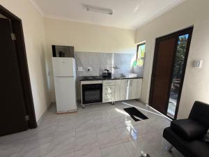 a kitchen with a refrigerator and a stove at Coastwave Guesthouse CBD in Walvis Bay