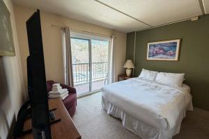 a bedroom with a bed and a window at Seasons 303 in Warren +14 photos