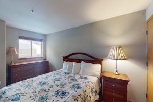a bedroom with a bed and a window at Wildernest Gore Trail Condo in Silverthorne +55 photos
