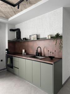a kitchen with a sink and a counter top at Апартамент САМИ 102 in Dobrich