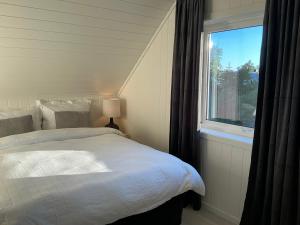 a bedroom with a bed and a window at Cozy Home in Sortland in Sortland