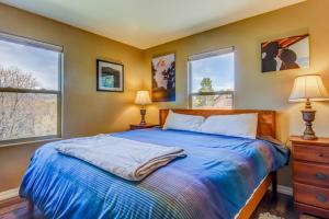 a bedroom with a blue bed and two windows at La Plata View in Durango