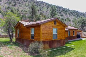 a log cabin with a mountain in the background at La Plata View in Durango