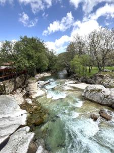 a river with rocks and trees on the side at Baelo Claudia in Navalguijo