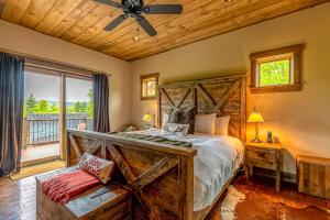a bedroom with a large bed with a ceiling fan at Mountain Estate Main House in Newry +72 photos