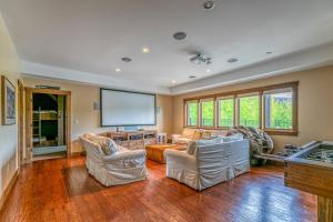 a living room with two couches and a large screen at Mountain Estate Main House in Newry
