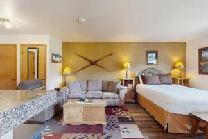 a hotel room with a bed and a couch at Blue River Escapade in Breckenridge +65 photos
