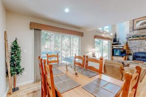 a dining room with a table and a fireplace at Mountain Breeze in Breckenridge