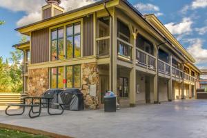 a building with a picnic table in front of it at Romance at Riverbends' Snowflake Lift in Breckenridge