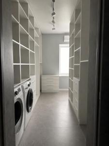 a laundry room with a washer and dryer at Graphite House in Kyiv