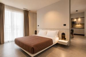 a bedroom with a large bed and a large window at Amare Suite & Apartments in Bellaria-Igea Marina