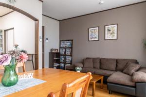 a living room with a table and a couch at 青柳館 Aoyagi-Kan in Hakodate +81 photos