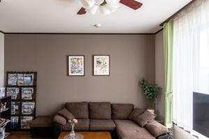 a living room with a couch and a ceiling fan at 青柳館 Aoyagi-Kan in Hakodate