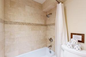 a bathroom with a tub and a toilet and a shower at Eagles Nest in Vail +15 photos