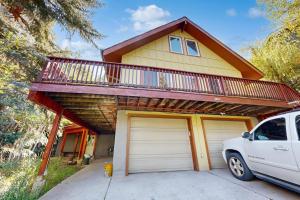a house with a balcony and two garage doors at Eagles Nest in Vail