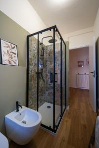 a bathroom with a glass shower and a sink at Petra's House in Lenno +29 photos