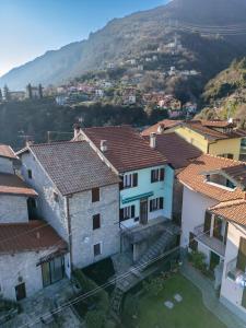 an aerial view of a town with mountains in the background at Petra's House in Lenno