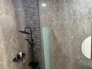 a bathroom with a shower with a glass shower at Qiana House in Manggis