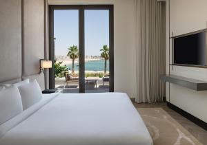 a hotel room with a bed and a television at Ray Hotel by Cloud 7 in Kuwait +80 photos