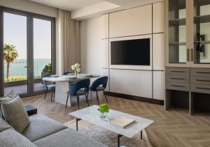 a living room with a couch and a table at Ray Hotel by Cloud 7 in Kuwait