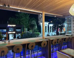 a bar with a view of a city at night at Hotel Park in Batumi