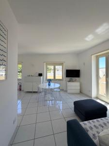 a living room with a table and a tv at Capresella luxury apartment in Capri