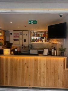 a bar with a flat screen tv above a counter at çam otel in Fethiye