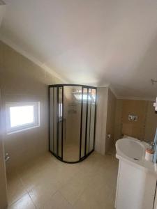 a bathroom with a shower and a toilet and a sink at çam otel in Fethiye +23 photos