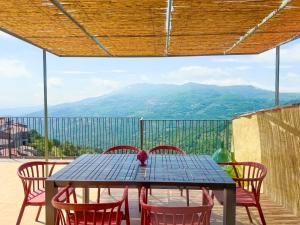 a table and chairs with a view of mountains at Rocha Suites in Rocca Cilento