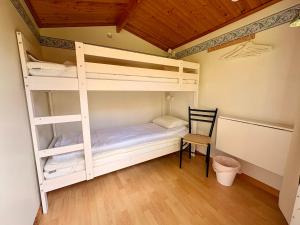 a room with two bunk beds and a chair at B&B Parkgården Leksand in Leksand