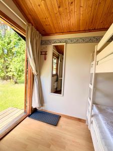 a room with a bunk bed and a mirror at B&B Parkgården Leksand in Leksand