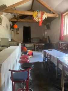 a room with tables and chairs and a table withools at Auberge de Lascours in Ceilhes-et-Rocozels +8 photos