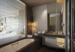 a bathroom with a bath tub and a sink at Hyatt Regency Suzhou in Suzhou