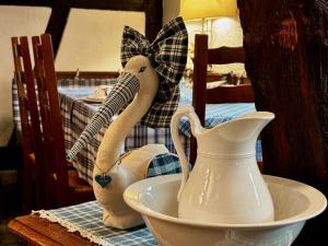 a white vase sitting in a bowl on a table at Maison Kieffer - Hotel & Vins d'Alsace in Itterswiller