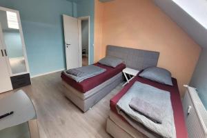 two beds in a room with a staircase at Privilege - Viel inklusiv! in Viersen +9 photos