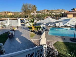 a view of a patio and a swimming pool at Albamaris Guest House in Botricello