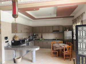 a kitchen with a table and a dining room at Villa khaddouj Marrakech in Marrakesh
