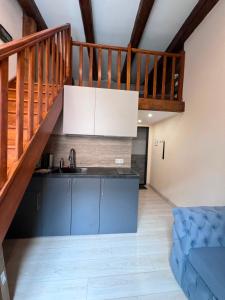 a kitchen with a sink and a staircase at Chorni vivtsi in Chernivtsi