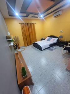 a large room with a bed in the middle of it at Royal Zam Résidence in Ouagadougou