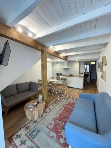 a living room with a blue couch and a table at Hotel Apartamentos Casas da Fortaleza in Lugo