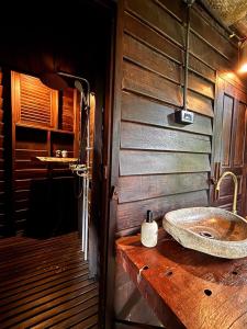a bathroom with a sink on a wooden wall at The Rock Lodge in Ban Nahin-Nai (1) +124 photos