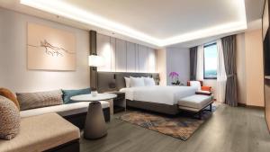 a hotel room with a bed and a couch at M Hotel Singapore City Centre in Singapore +55 photos