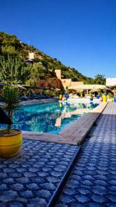 a large swimming pool with blue water in a resort at Auberge le Refuge in Agadir +78 photos