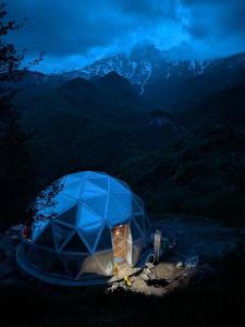 a blue tent on top of a mountain at night at Knowledge Temple - Keni in Kapan