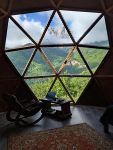 a room with a window with a chair and a laptop at Knowledge Temple - Keni in Kapan