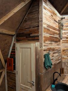 a room with a wooden wall with a door at Knowledge Temple - Keni in Kapan
