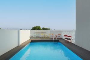 a swimming pool on the roof of a building at Swiss-Belexpress Cilegon in Cilegon